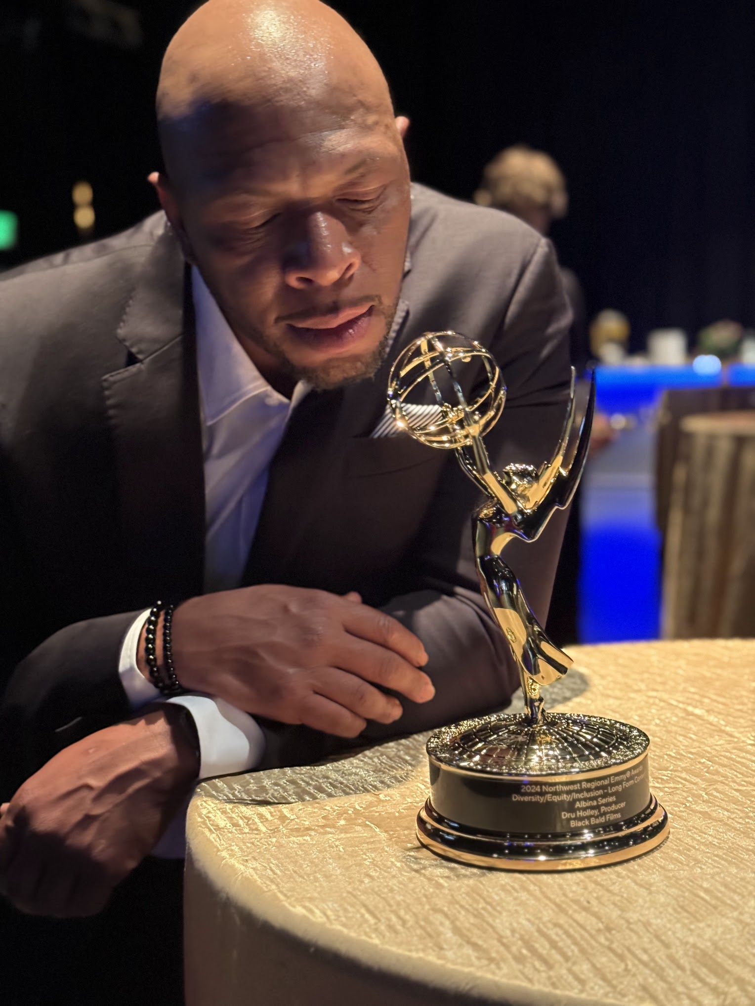 Dru Holley holding his Northwest Regional Emmy Award